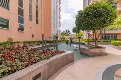 a courtyard in a building with trees and bushes at Studio at Venice Mall, near Airport, BGC & Makati in Manila