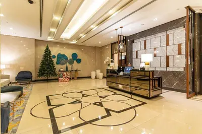 a lobby with a christmas tree in the middle at Studio at Venice Mall, near Airport, BGC & Makati in Manila