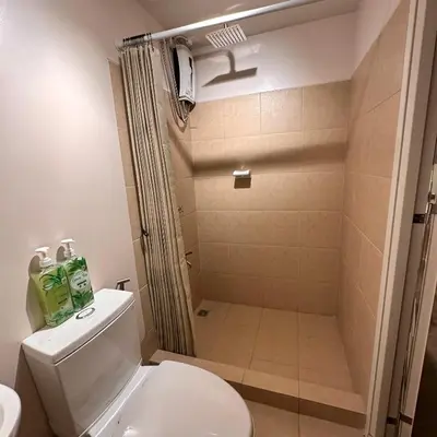 a bathroom with a shower and a toilet at Condo near Nuvali Laguna Technopark St Benedict Church in Bayabasan