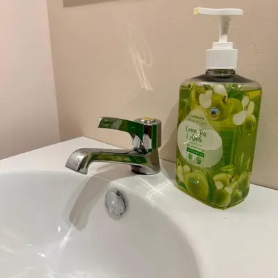 a bottle of soap sitting on top of a sink at Condo near Nuvali Laguna Technopark St Benedict Church in Bayabasan