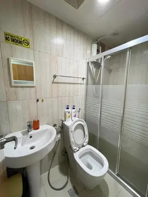 a bathroom with a toilet and a sink and a shower at 8 Adriatico in Manila
