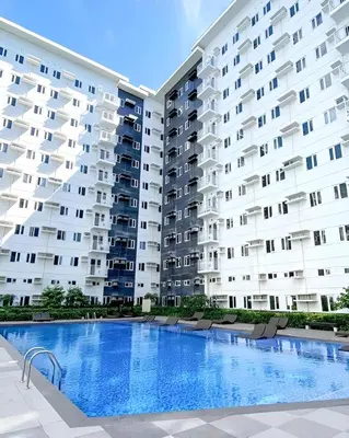 a large apartment building with a large swimming pool at Casa Aria at SMDC Charm Residences - No Parking in Manila