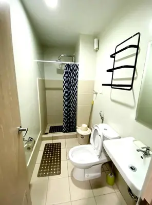 a bathroom with a toilet and a sink and a shower at Casa Aria at SMDC Charm Residences - No Parking in Manila