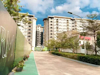a street with tall buildings and a green sidewalk at Casa Aria at SMDC Charm Residences - No Parking in Manila