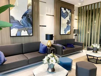 a living room with two couches and blue pillows at Casa Aria at SMDC Charm Residences - No Parking in Manila