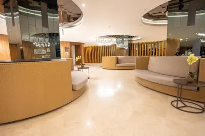 a lobby with couches and tables in a building at Concrete Palms near MOA w/ awesome view of Manila in Manila
