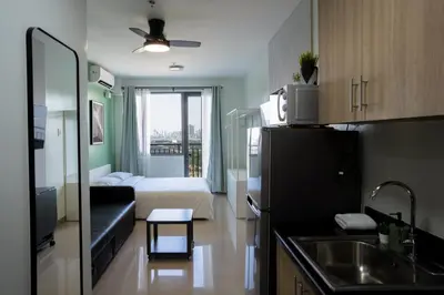 a small apartment with a kitchen and a living room at Concrete Palms near MOA w/ awesome view of Manila in Manila