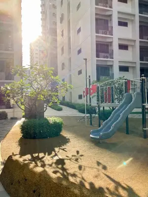 a playground with a slide in front of a building at Concrete Palms near MOA w/ awesome view of Manila in Manila