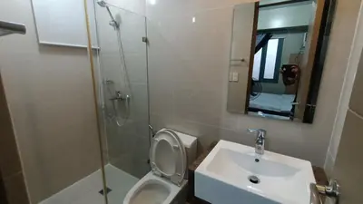 a bathroom with a toilet and a sink and a shower at 1 bedroom Condotel near Terminal3 Airport in Manila