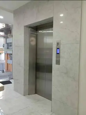 a elevator in a building with a sign on it at St. Marvin Studio M603 in Manila