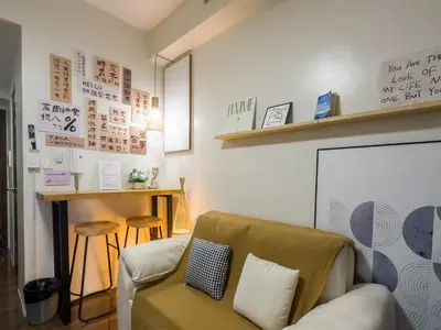 a living room with a couch and a chair at GemstoneBR in SMDC Air Residences in Manila