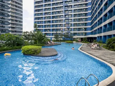 a swimming pool with a large building in the background at GemstoneBR in SMDC Air Residences in Manila