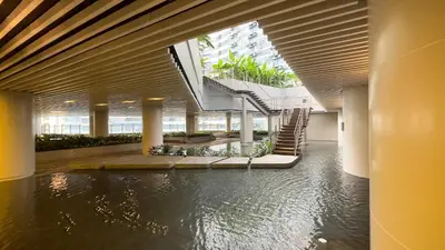 a large building with a pool of water in the middle at GemstoneBR in SMDC Air Residences in Manila