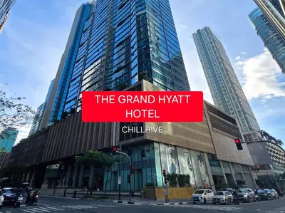 a large building with a sign that reads the grand hyatt hotel at Chillhive Condo In Bgc Near Uptown Mall #ournw17a in Manila