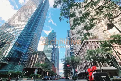 a city street with tall skyscrapers in a city at Chillhive Condo In Bgc Near Uptown Mall #ournw17a in Manila