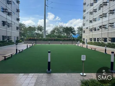 a large artificial lawn in the middle of a building at SMG - Studio@Green2: Wi-fi, Netflix, Swim & Relax in Cavite