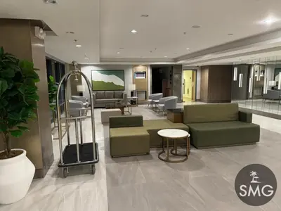 a hospital lobby with a waiting room with green chairs and a waiting room at SMG - Studio@Green2: Wi-fi, Netflix, Swim & Relax in Cavite