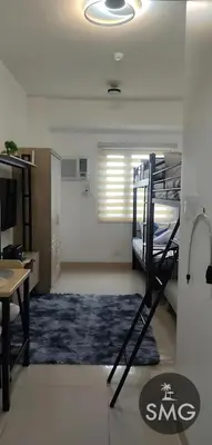 a room with two bunk beds and a desk at SMG - Studio@Green2: Wi-fi, Netflix, Swim & Relax in Cavite