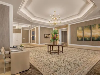 a lobby with a table and a chandelier at Discovery Primea in Manila