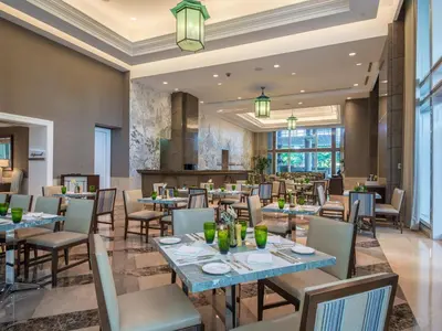 a dining room with tables and chairs and a restaurant at Discovery Primea in Manila