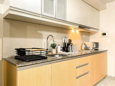 a kitchen with a sink and a counter top at BGC 1BR Condo Steps from Grand Hyatt #ournw18l in Manila