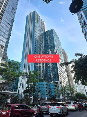 a street sign in front of some tall buildings at BGC 1BR Condo Steps from Grand Hyatt #ournw18l in Manila