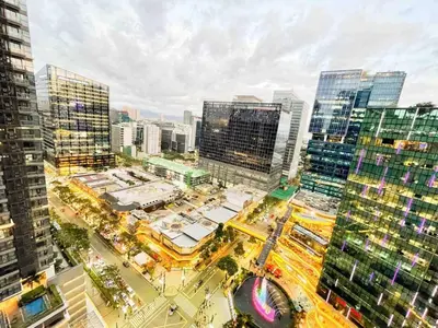 an aerial view of a city with tall buildings at Cozy Bgc Stay Near Uptown Mall & Hyatt #ournw24l in Manila