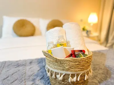 a basket on a bed with toilet paper and drinks at Premium Bgc Staycation, Uptown Area #ournw27b in Manila