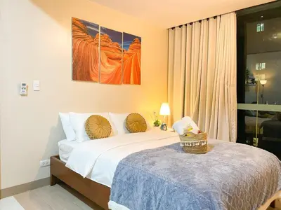a bedroom with a bed and a large window at Premium Bgc Staycation, Uptown Area #ournw27b in Manila