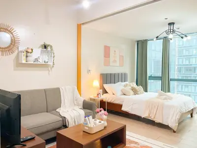 a living room with a couch and a bed at Bgc Condo Near Uptown Mall, Grand Hyatt #ournw25b in Manila