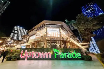 a downtown paradise sign in front of a building at night at Bgc Prime, Near Uptown Mall, Grand Hyatt #ournw7m in Manila