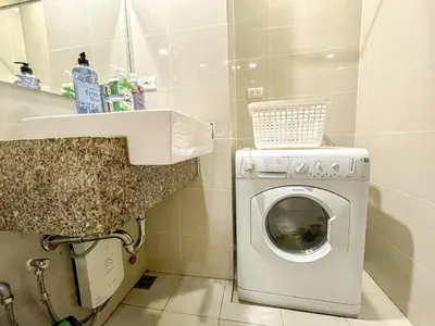 a bathroom with a washing machine and a sink at Bgc Prime, Near Uptown Mall, Grand Hyatt #ournw7m in Manila