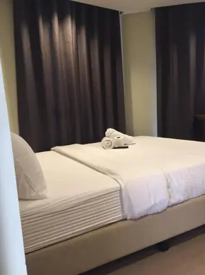two beds with towels on top of them in a room at Spacious Studio Apartment B203 in Manila