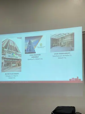 a projection screen with a presentation about different buildings at Staycation near SLMEC, US Embassy and Supreme Court in Manila