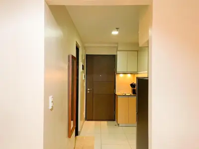 a hallway leading to a kitchen with a door at Cozy Stay In Bgc Near Uptown Mall #oursw11d1 in Manila