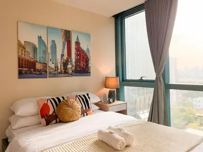 a bedroom with a bed and a large window at Upscale Bgc Experience 1br Condo #oursw17c2 in Manila