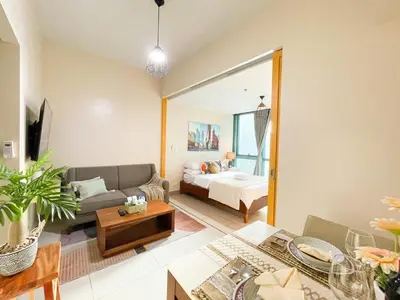 a living room with a couch and a bed at Upscale Bgc Experience 1br Condo #oursw17c2 in Manila