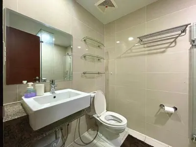 a white bathroom with a sink and a toilet at Luxury Bgc Condo At Uptown Area #oursw21e in Manila