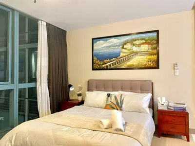 a bedroom with a bed with a painting on the wall at Luxury Bgc Condo At Uptown Area #oursw21e in Manila