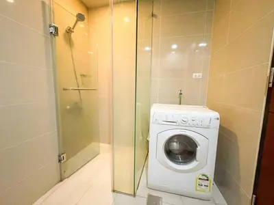 a washing machine in a bathroom with a shower at Bgc Staycation Across Uptown Mall #oursw29f in Manila