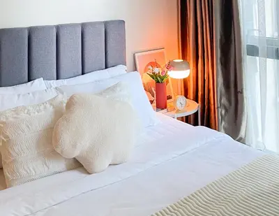 a white bed with a teddy bear on it at Luxury BGC Condo, Steps to Uptown Mall #oursw31i in Manila