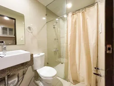 a bathroom with a toilet and a shower and a sink at Bgc 1br Condo Across Uptown Mall, Hyatt #oursw7b2 in Manila