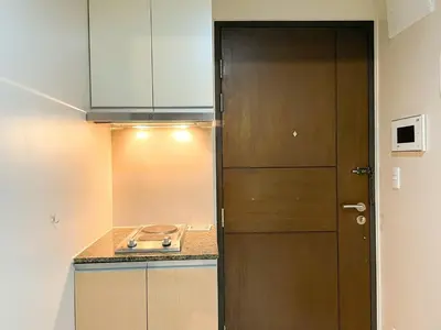 a kitchen with a wooden door and a sink at Bgc 1br Condo Across Uptown Mall, Hyatt #oursw7b2 in Manila