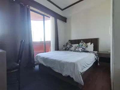 a bedroom with a large bed with a window at Room accommodation in Manila