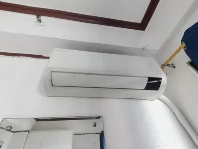 a white object is hanging on a wall at Room accommodation in Manila