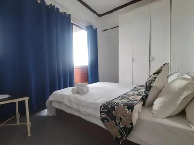 a bedroom with a bed with a teddy bear on it at Room accommodation in Manila