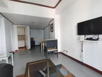 a living room with a flat screen tv on a wall at Room accommodation in Manila
