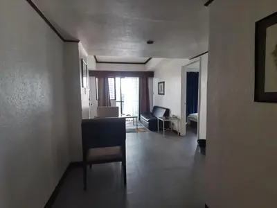 a living room with a chair and a couch at Room accommodation in Manila