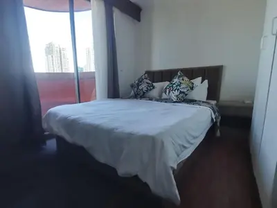 a bedroom with a bed with pillows and a window at Room accommodation in Manila