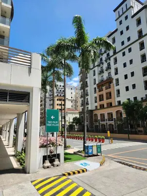 a street with palm trees next to a building at Runway Walk Studio - Near NAIA Terminal3 in Manila